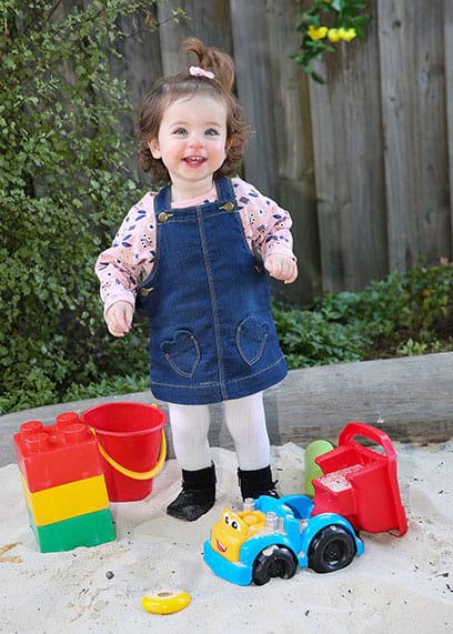 strike a pose girl in sandpit